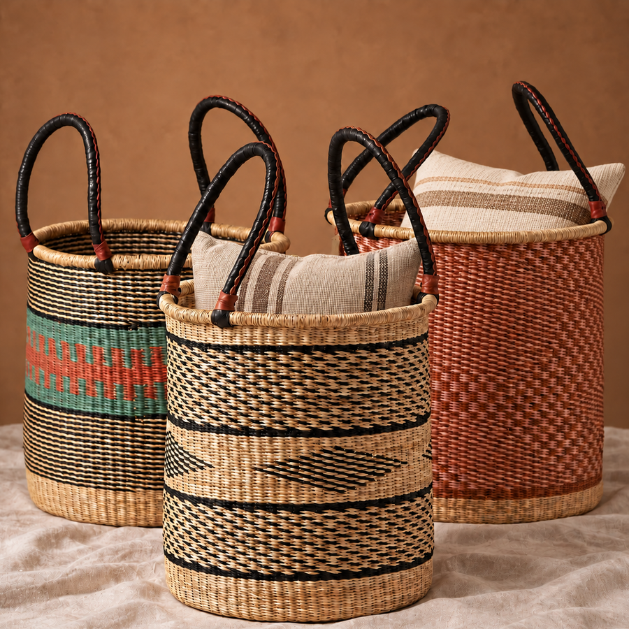 Three tall woven baskets with leather handles, holding striped cushions